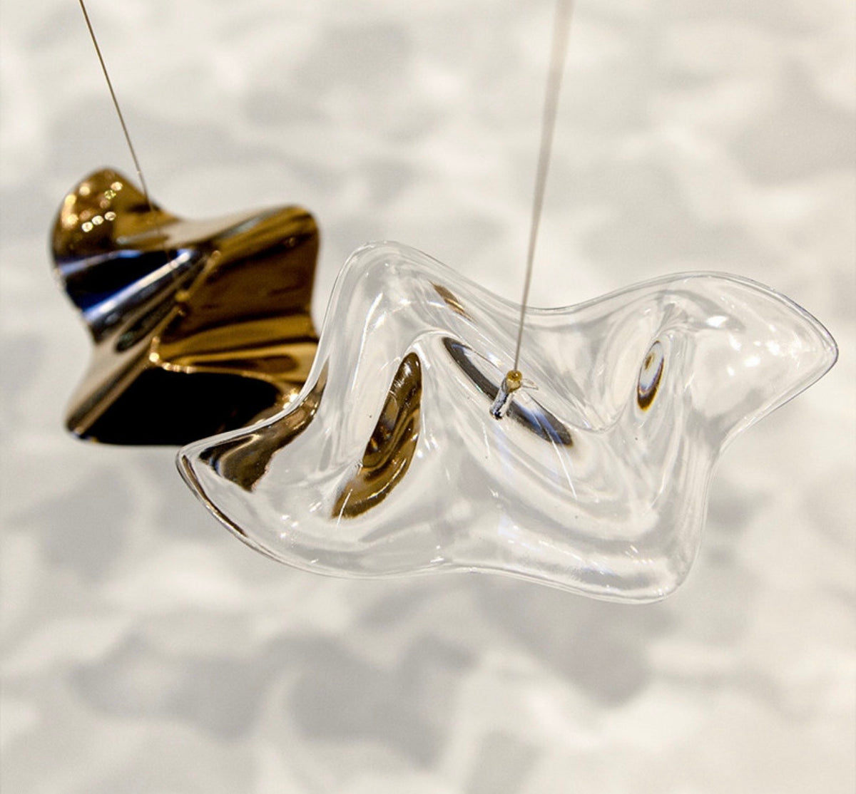 Close-up of bronze and clear glass leaves on the Falling Leaves chandelier